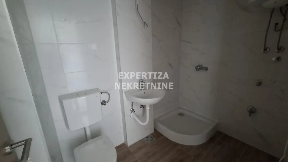 Smaller bathroom with sanitary ware and a shower cabin.