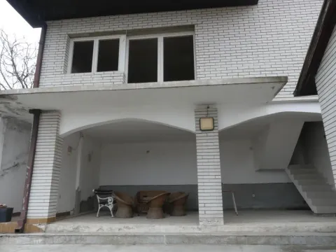 Covered ground floor terrace of the house with seating furniture. - image 3