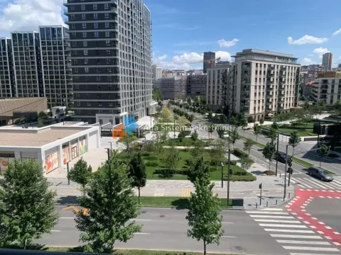 View from the window overlooking surrounding buildings, streets, and green areas. - image 6