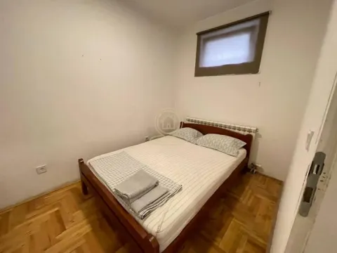 Smaller bedroom with a double bed and wooden flooring. - image 11