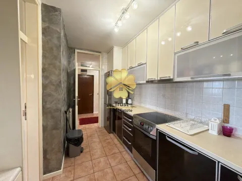 Small equipped kitchen with white and dark cabinets. - image 8