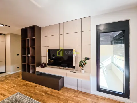 Living room with a TV and built-in shelving. - image 8