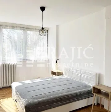 Bright bedroom with a double bed and a window. - image 3