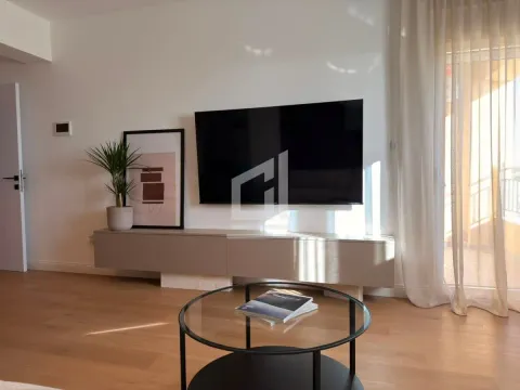 Living room with TV, low sideboard, and glass coffee table. - image 9
