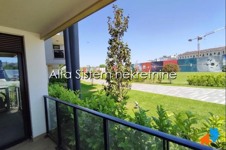 View from the terrace overlooking the landscaped courtyard and green areas.