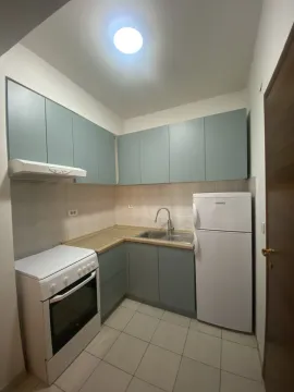 Small kitchen with grey-blue cabinets and appliances. - image 15