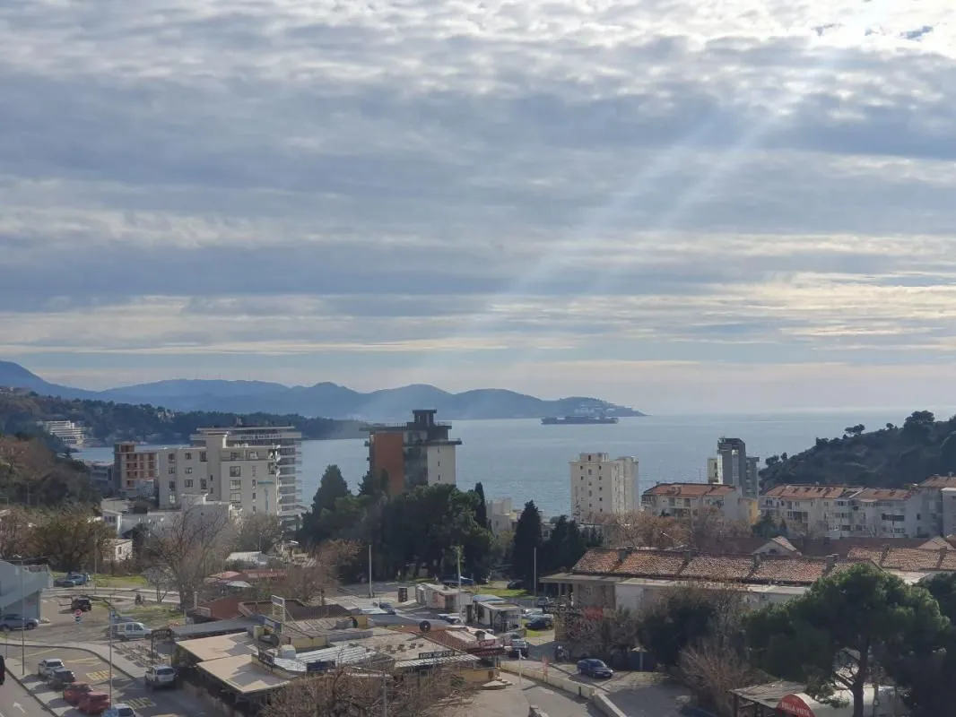 View from the window overlooking the city, sea and surrounding mountains.