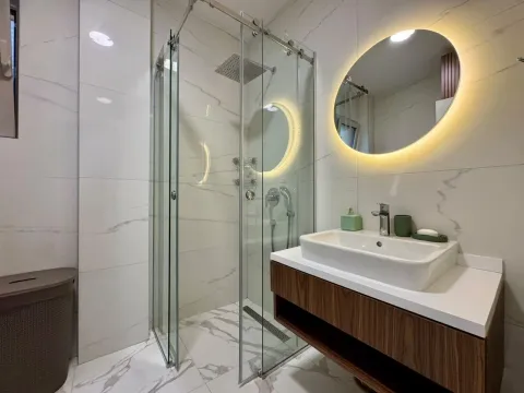 Modern bathroom with a walk-in shower and washbasin. - image 16