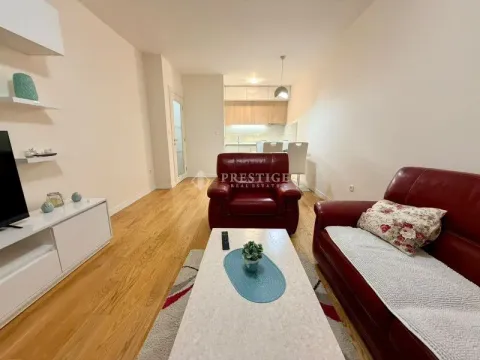 Living room with red leather furniture and a dining area in the background. - image 2