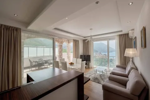 Spacious living room with dining area and access to a terrace with sea view. - image 8