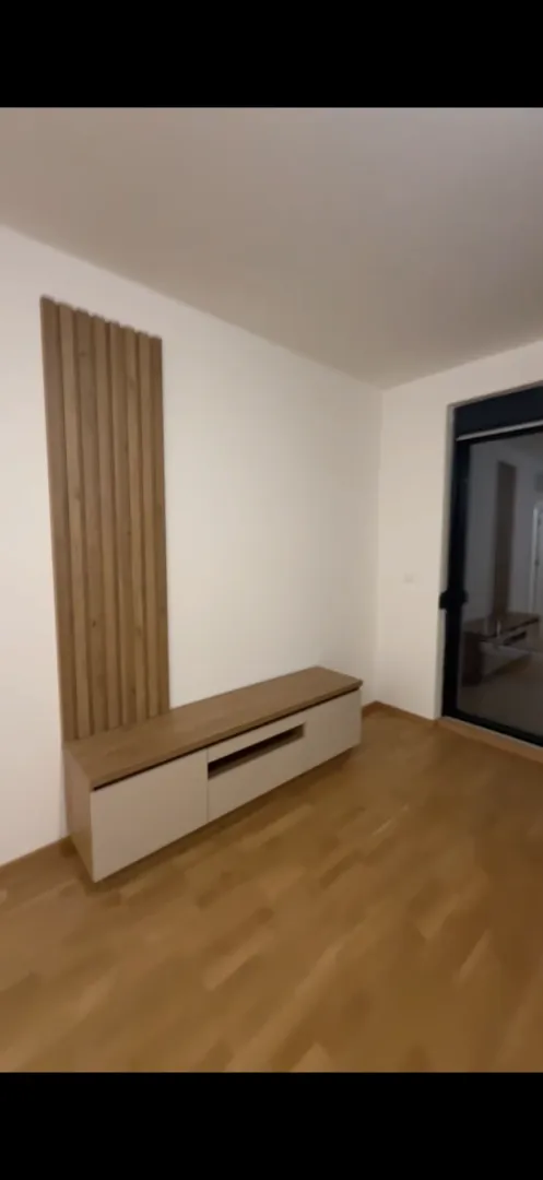 Living room with a wooden wall panel and a media console.