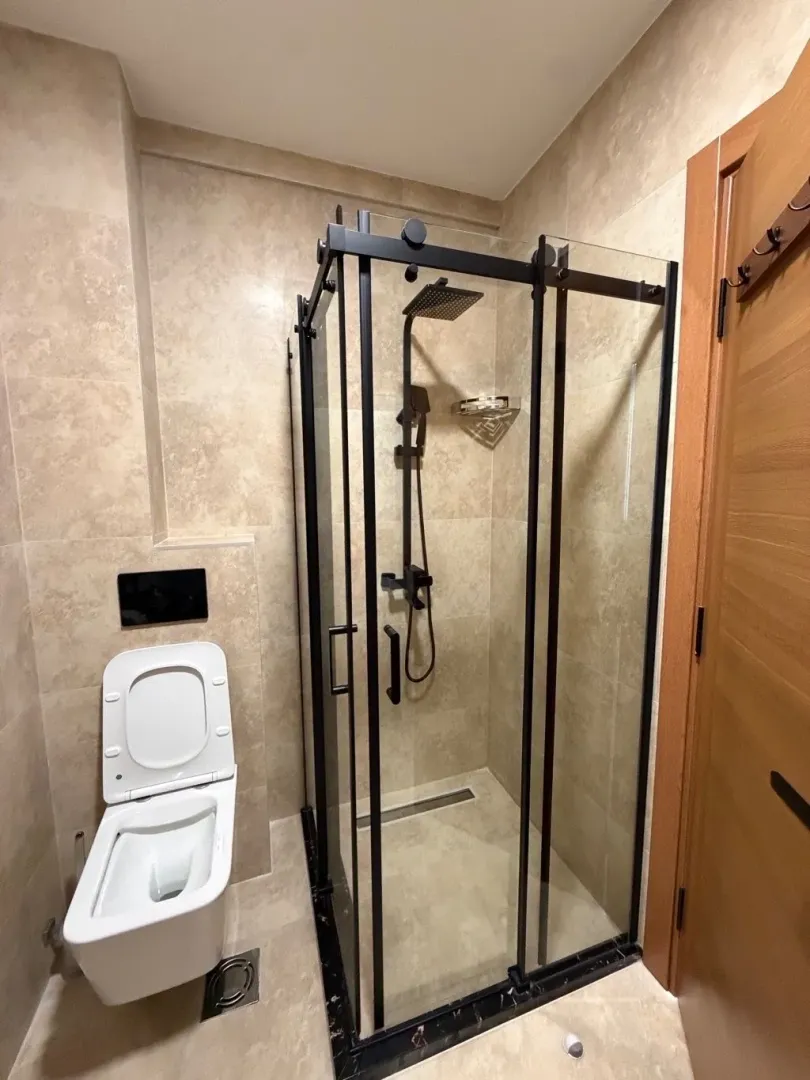 Modern bathroom with a walk-in shower and built-in sanitaryware.
