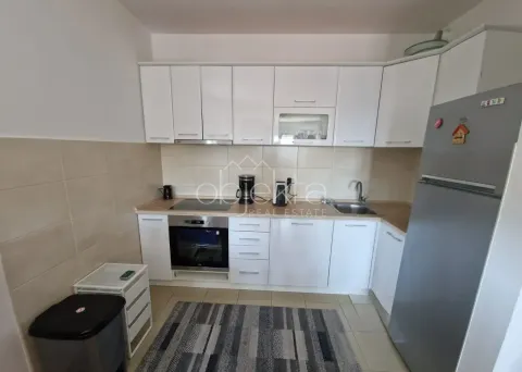 Kitchen equipped with white cabinetry, built-in appliances and a refrigerator. - image 5