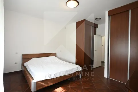 Furnished bedroom with a double bed and wooden wardrobes. - image 13