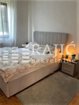 Furnished bedroom with a double bed and a nightstand. - image 4