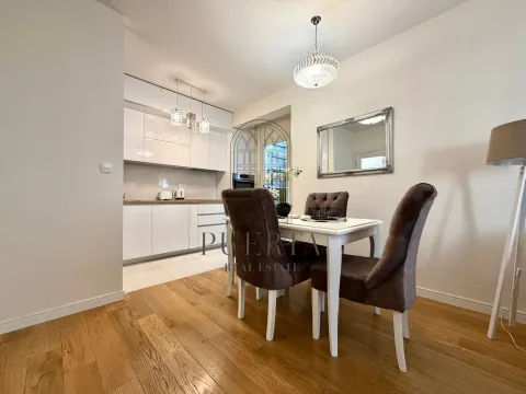 Modern kitchen with a dining area and white cabinetry. - image 6