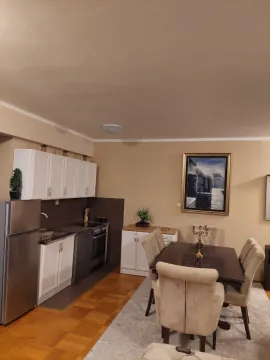 Kitchen with a dining area and white cabinetry. - image 6