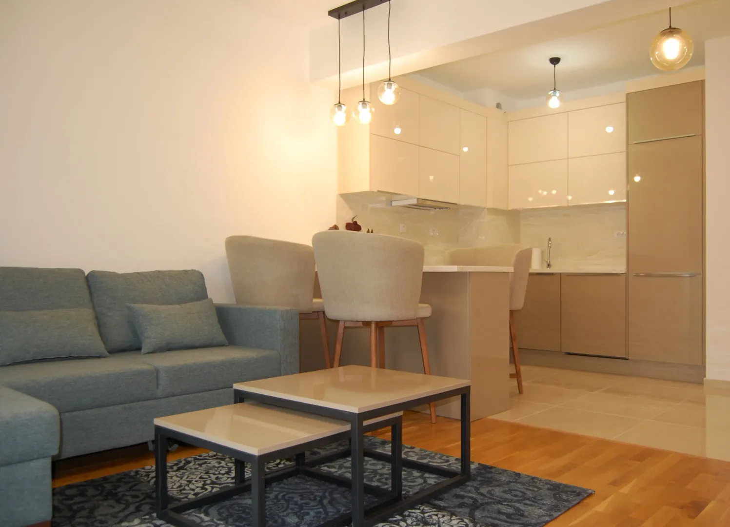 Living room connected to the kitchen and dining area in a modern interior.