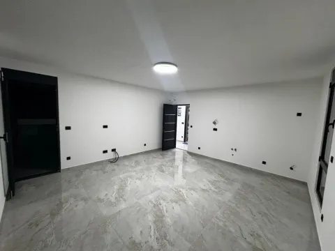 Empty room with glossy floor tiles and white walls. - image 8