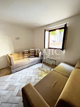 Living room with seating furniture and a window. - image 11