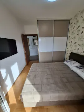 Bright bedroom with a large bed and a built-in wardrobe. - image 16