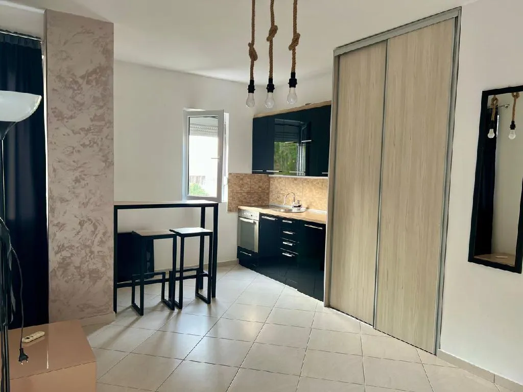 Small kitchen with a dining table and built-in appliances.
