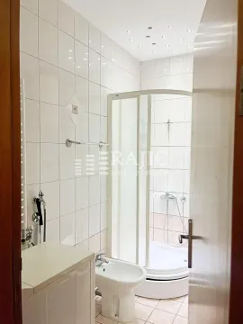 Bathroom with a shower cabin, bidet, and ceramic tiles. - image 15