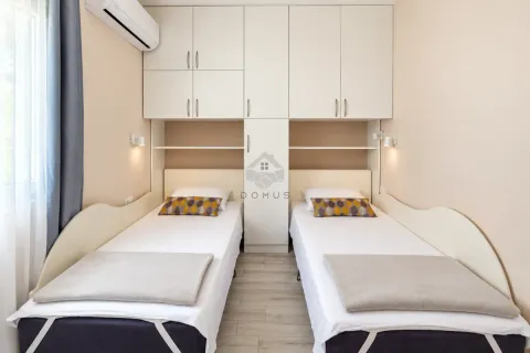 Bedroom with two single beds and fitted wardrobes. - image 28
