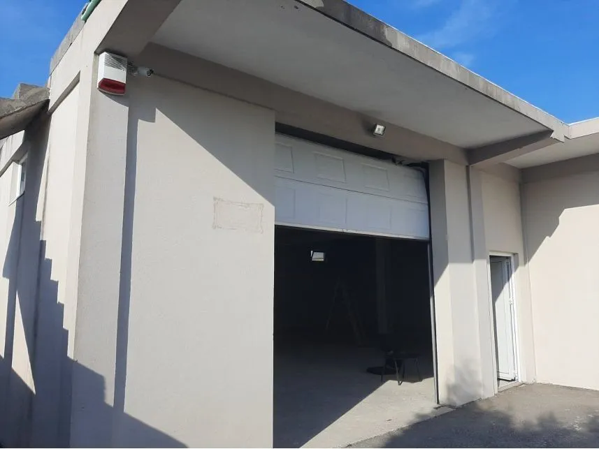 Exterior view of the building with a large garage door.