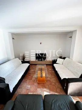 Living room with a sofa set and a TV. - image 3
