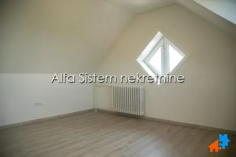 Empty attic room with parquet flooring, a radiator, and a rhomboid window. - image 16