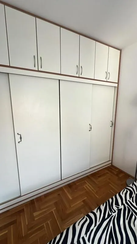Bedroom with a large built-in wardrobe and a bed.