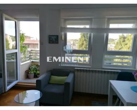 Living room with an armchair, coffee table, and access to the terrace. - image 3