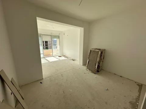 Empty room under construction with a view of the terrace and building materials. - image 7