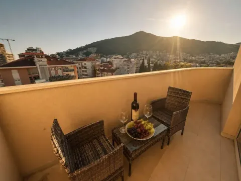 Furnished balcony with seating set and a view of the city and hill. - image 6