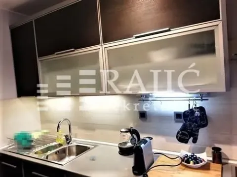 View of a modern equipped kitchen with workspace elements. - image 2