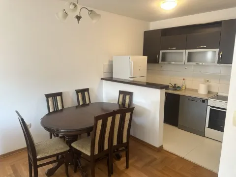 Kitchen with a dining table and chairs in a bright apartment. - image 2
