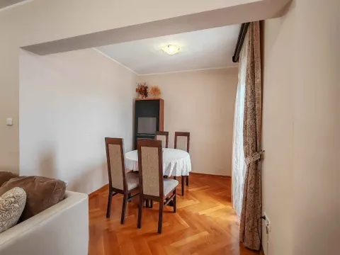Living room with a dining table and parquet flooring. - image 8