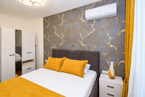 Furnished bedroom with a double bed, wardrobe, and decorative wallpaper. - image 23