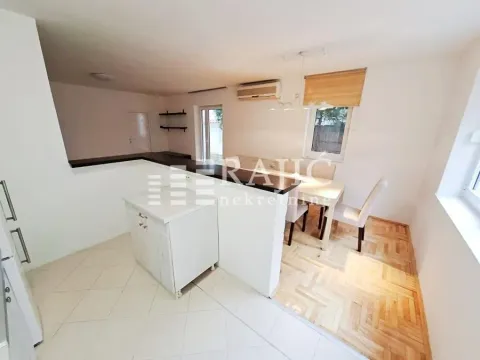 Interior view of the kitchen and dining area with parquet flooring. - image 6