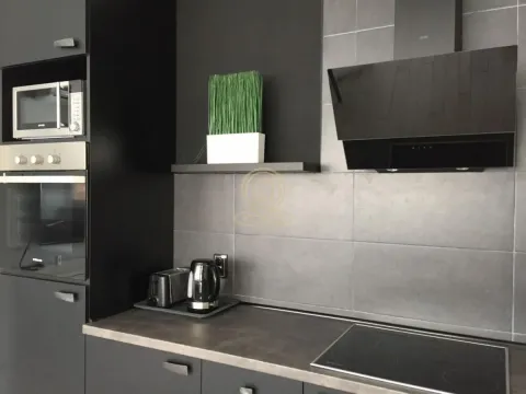 Moderna crna kuhinja sa ugrađenim aparatima i keramičkim pločicama. - image 9