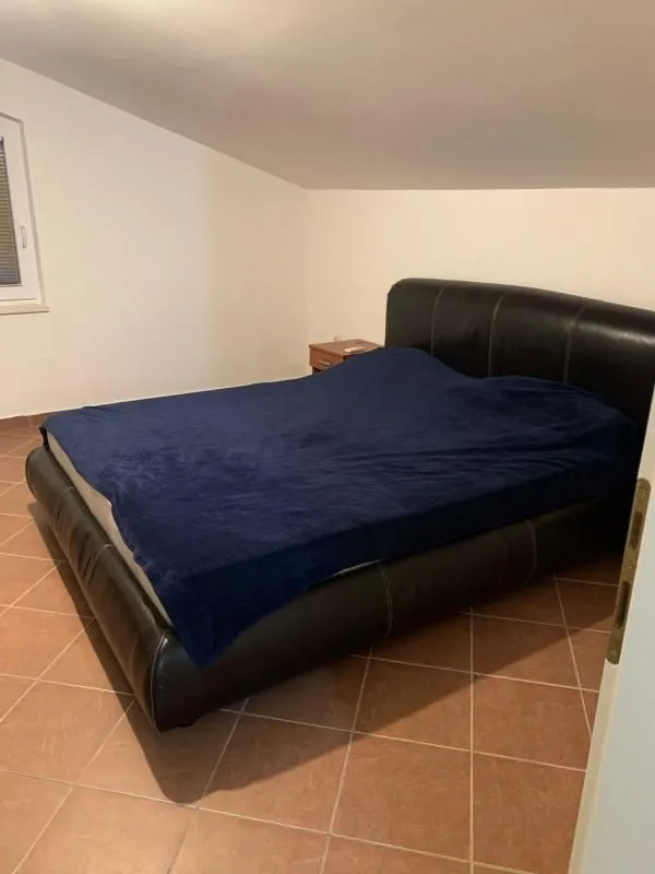 Bedroom with a double bed and tiled flooring.