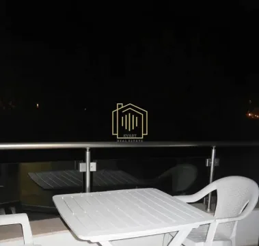Terrace with a white plastic table and chairs at night. - image 7