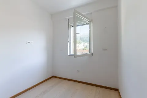 Prazna svijetla soba sa otvorenim prozorom i pogledom na naselje. - image 17