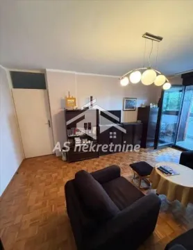 Living room with furniture, wooden flooring, and access to the terrace. - image 3