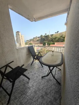 Manji natkriveni balkon sa stolom, stolicama i pogledom na okolinu. - image 10