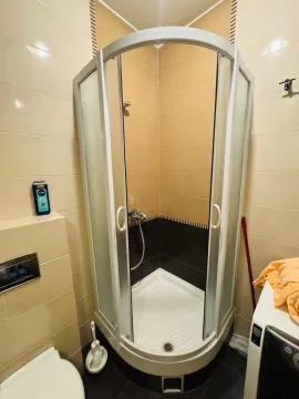 Small bathroom with a shower cabin and ceramic tiles. - image 6