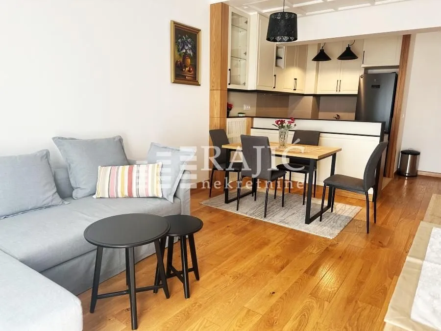 Living room with dining area and kitchen in the background.