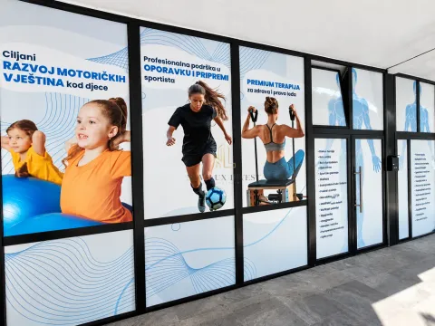 Commercial space facade with large glass shop windows and promotional stickers. - image 10