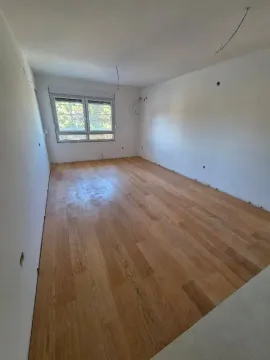 Empty room with installed hardwood flooring and white walls. - image 10